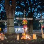 Candles burn at memorials for Angela Carr, Anolt Joseph Laguerre Jr. and Jerrald Gallion near the Dollar General store where they were shot and killed.